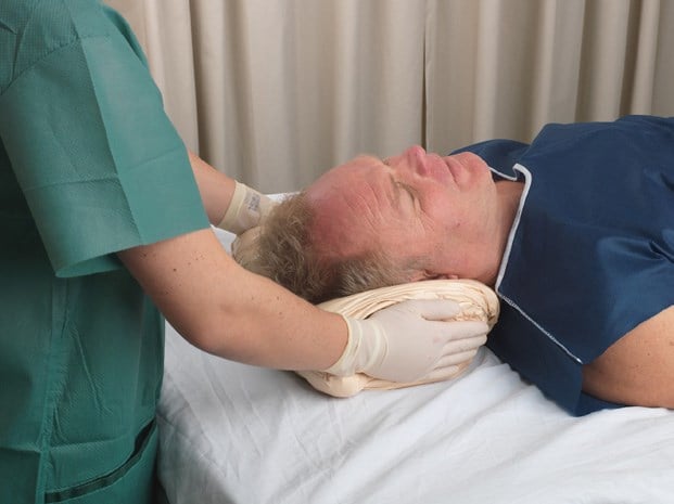 Mould Z-Flo so that it conforms to the shape of the head and fills in the cervical spine area