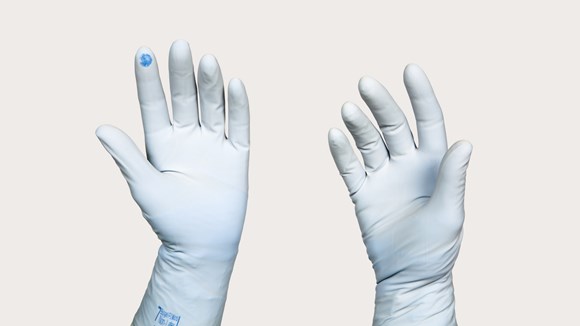 Gloved hand with puncture indication