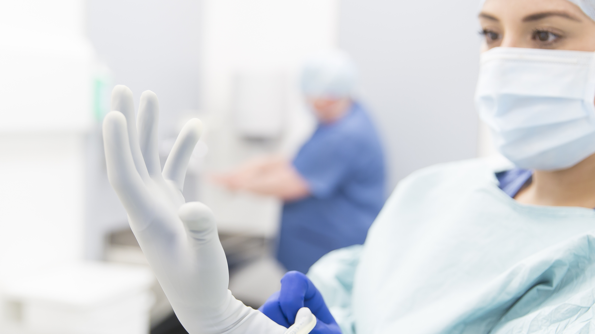 surgeon putting on biogel gloves