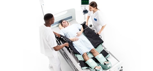 Nurses turning a patient